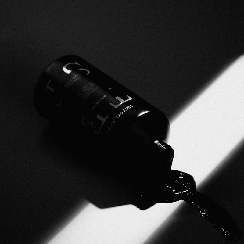 Liquid spilling out TEST BODY WASH bottle