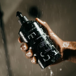 Holding TEST BODY WASH in the shower